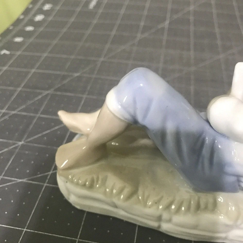 Vintage Porcelain Blue and White Boy Fish Figurine Propped Elbow‎ Reading